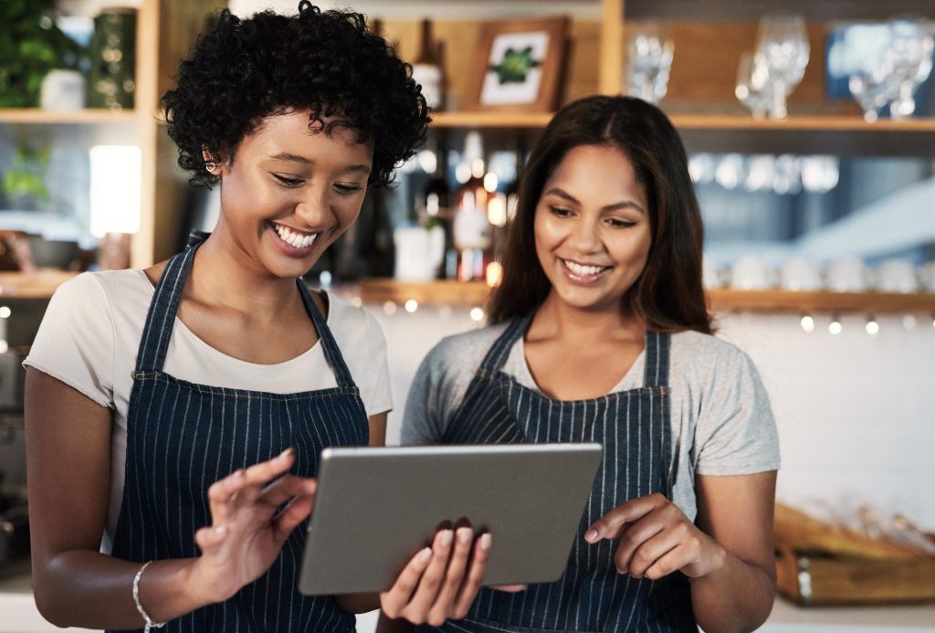 Hospitality workers using a tablet