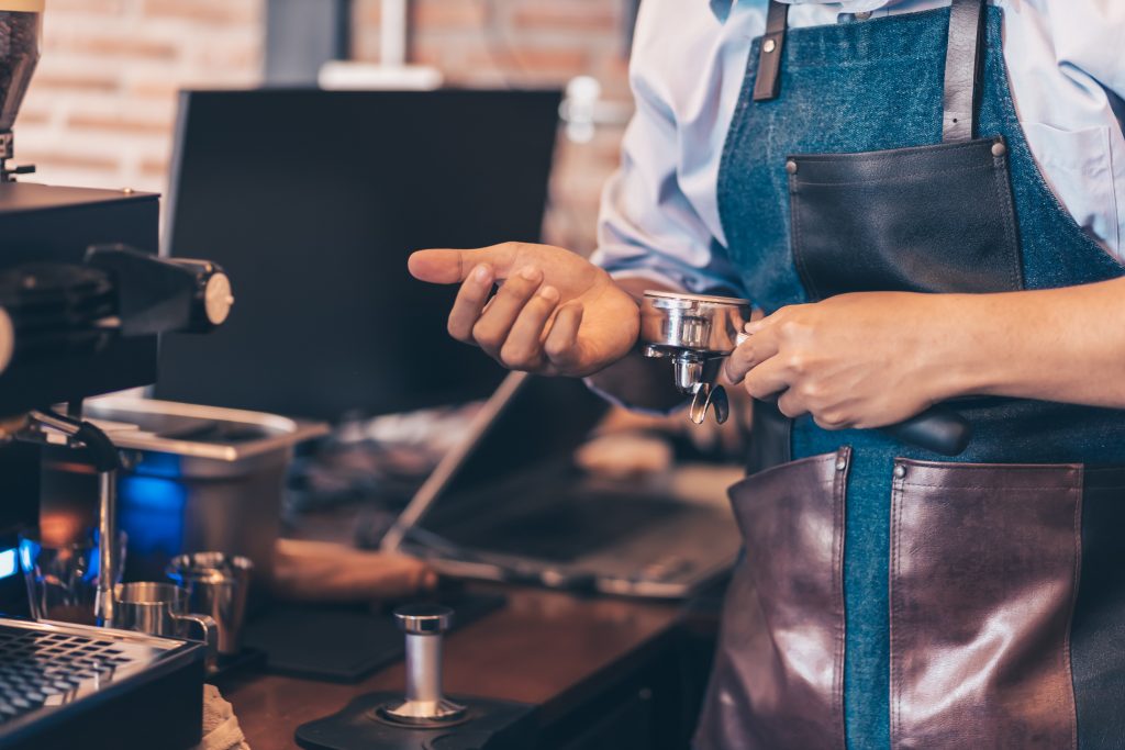 Barista making coffee in a cafe